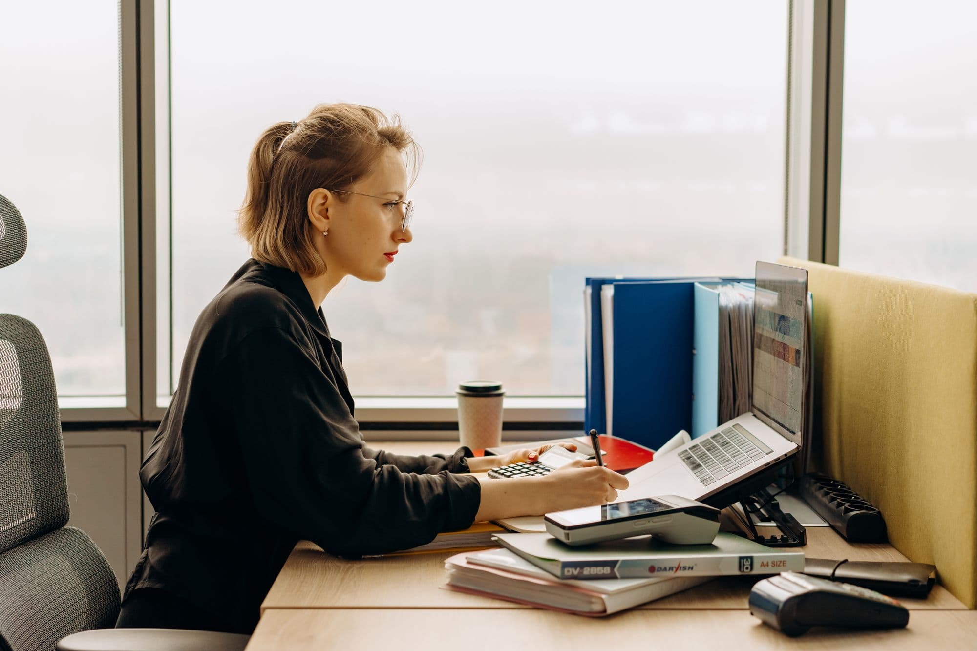 Accountant working at a laptop in a bright office