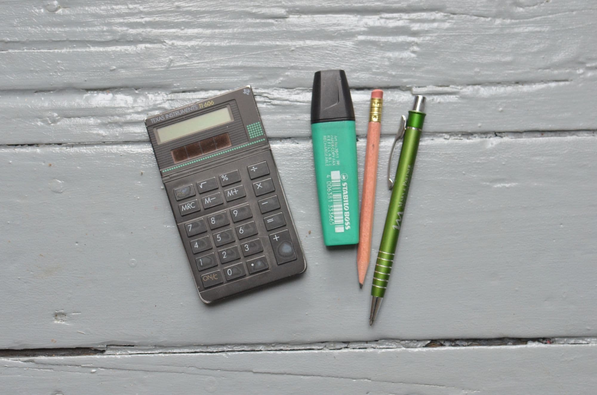 Calculator, notebook, and stationery prepared for monthly bookkeeping