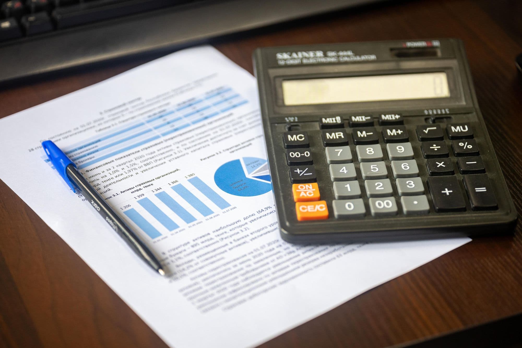 Financial report, calculator, and review notes on a desk