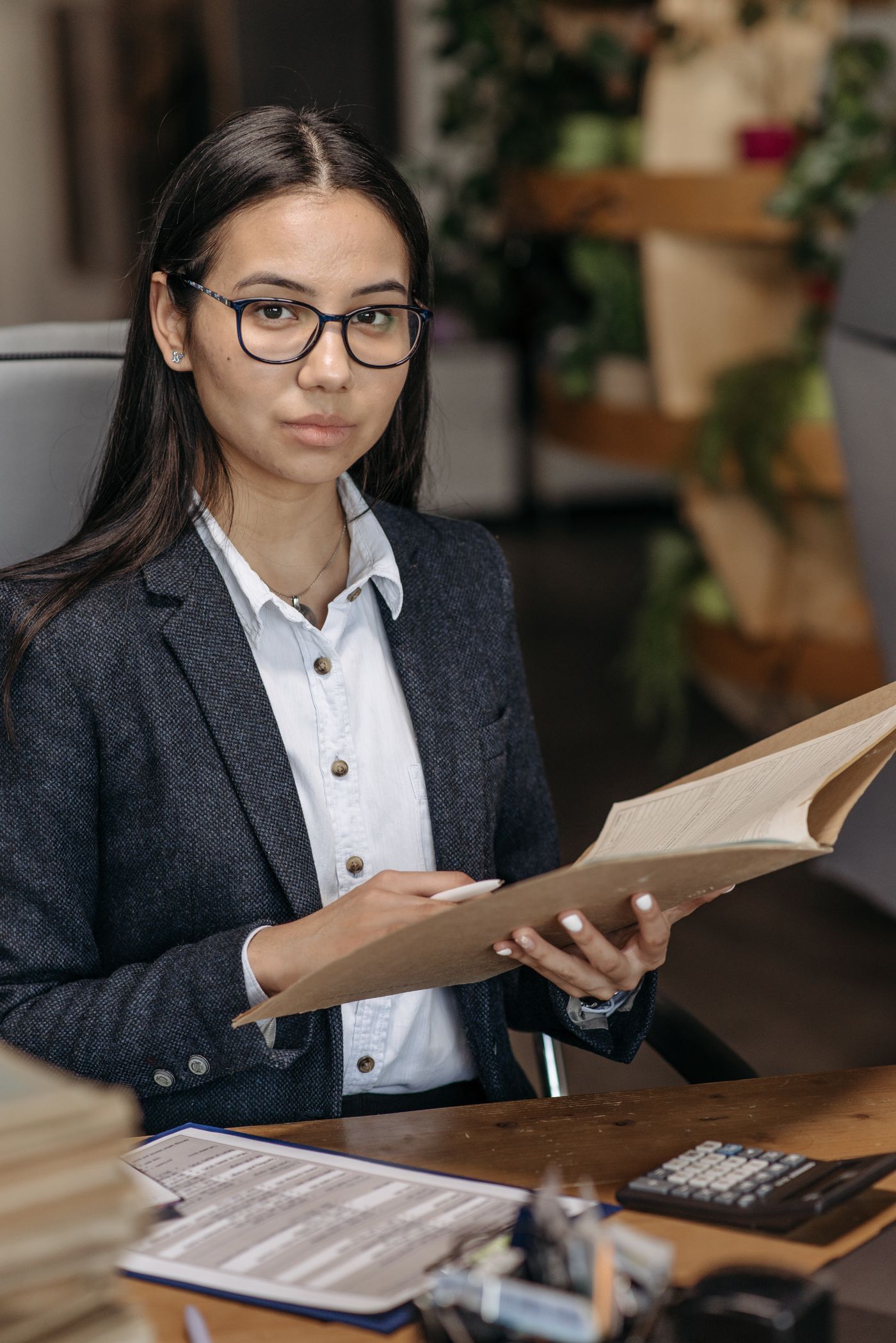 Accountant reviewing paperwork at her office desk