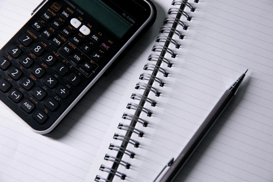 A notebook and calculator on a desk